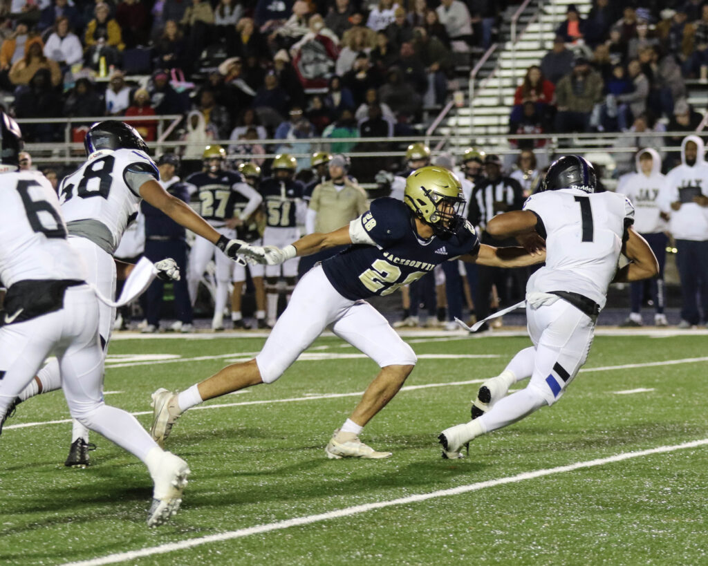 Jacksonville’s Darel Atkinson, Jr., tries to make a stop against Catholic-Montgomery quarterback Caleb McCreary on Friday. (Photo by Greg Warren/For East Alabama Sports Today)