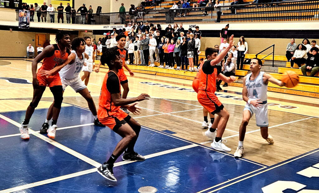 Jacksonville’s Devin Barksdale makes a cross-court pass against Alexandria on Monday at Jacksonville. (Photo by Joe Medley)