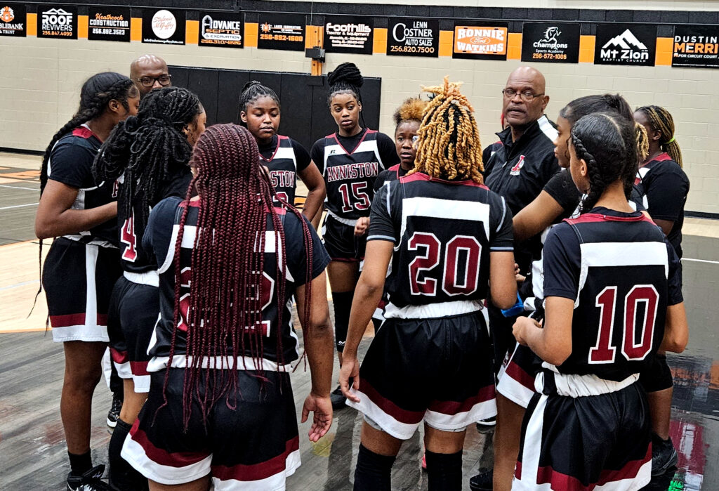 Anniston coach Eddie Bullock talks to his team during a timeout on Tuesday at Alexandria. The Bulldogs improved to 14-0. (Photo by Joe Medley)