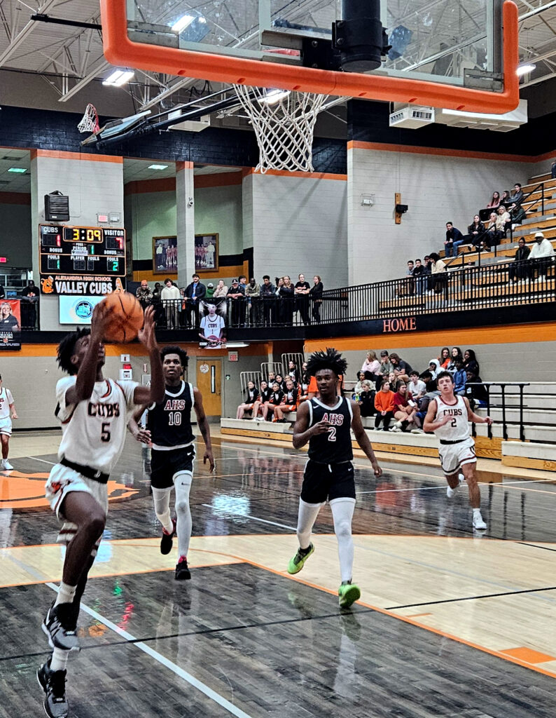 Alexandria’s Jaylen Henderson gets a fast-break bucket for two of his nine points against Anniston on Tuesday at Alexandria. (Photo by Joe Medley)