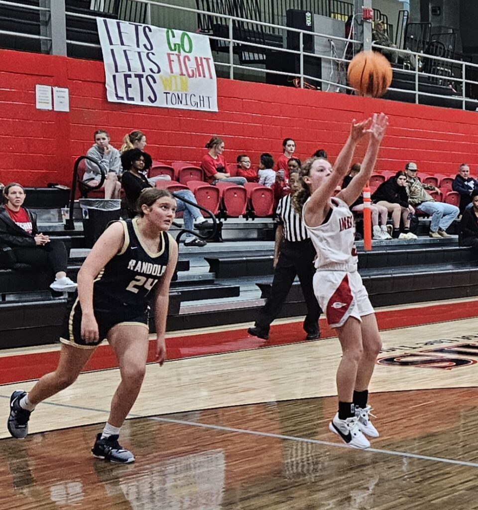 Ohatchee’s Mollee Barnes shoots a 3-pointer as Randolph County’s Lizzie Milam gives chase during their game Wednesday in the Heflin Holiday Hoops Classic. (Photo by Joe Medley)