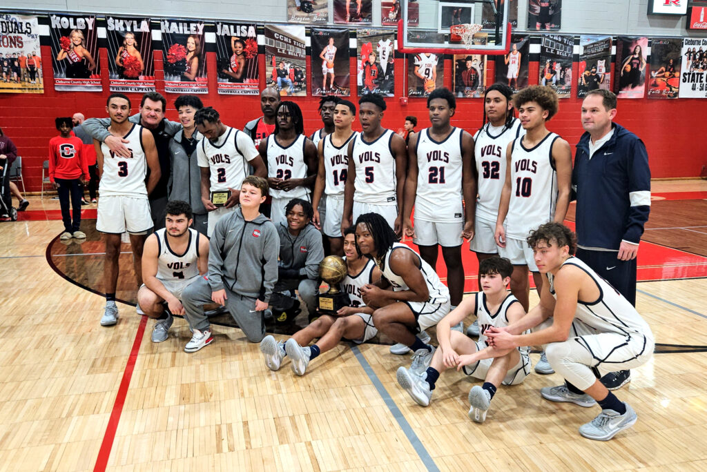 Central-Clay’s boys celebrate Friday after repeating as Heflin Holiday Hoops Classic champion. (Photo by Joe Medley)