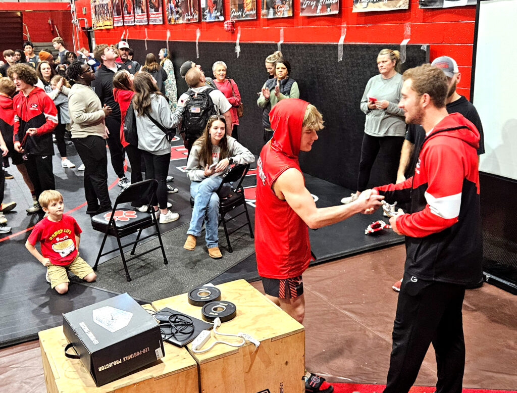 Cleburne County’s Austen Mayfield receives his trophy as 2024 Rumble in the Jungle most valuable wrestler. He won the 146-pound class by pin. (Photo by Joe Medley)