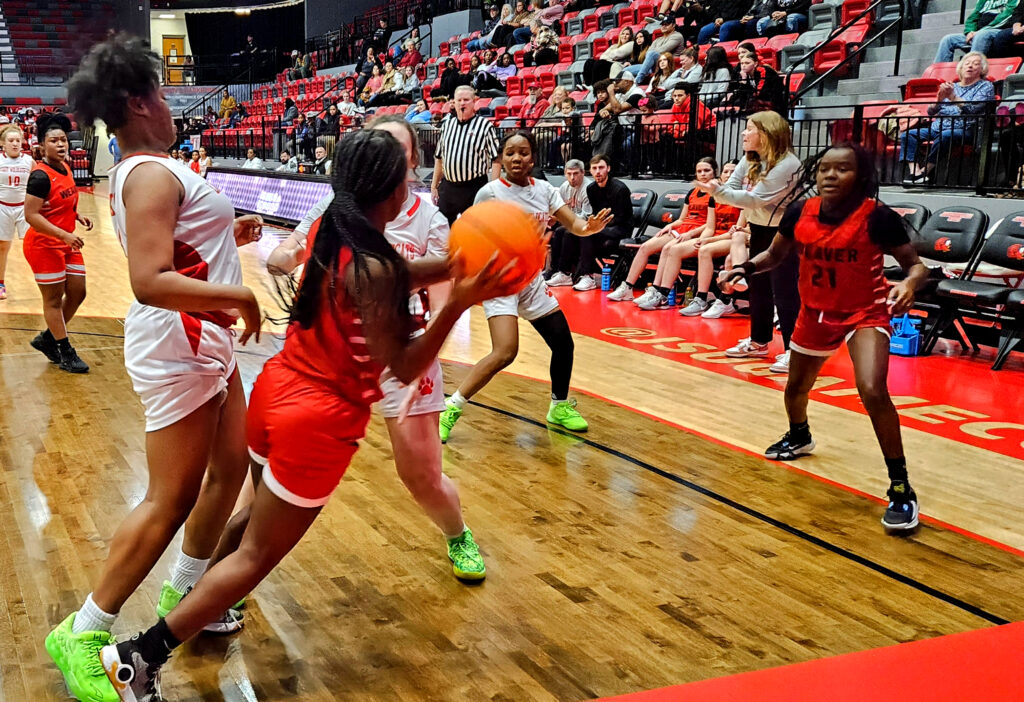 Weaver’s Erionna Richmond tries to advance the ball under pressure from Saks’ Madison Turner and Camrie Denham during Saturday’s action in the Calhoun County Tournament at Pete Mathews Coliseum. (Photo by Joe Medley)