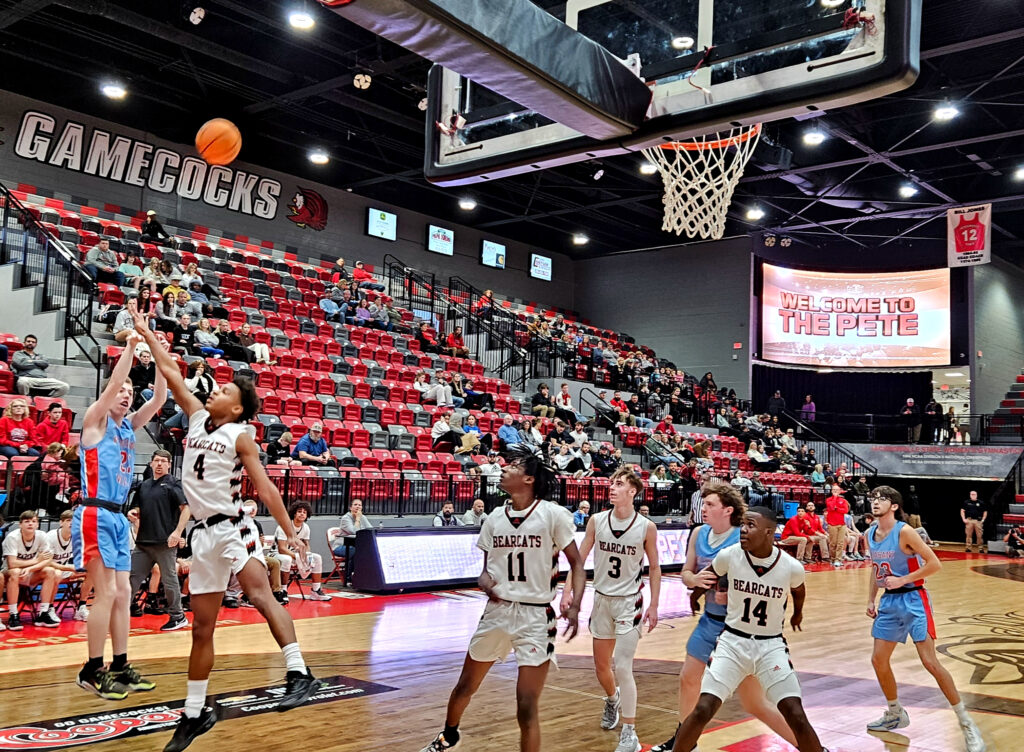 Pleasant Valley’s Knox Taylor shoots as Weaver’s KeShawn Allen defends during Monday’s action in the Calhoun County tournament at Pete Mathews Coliseum. (Photo by Joe Medley)