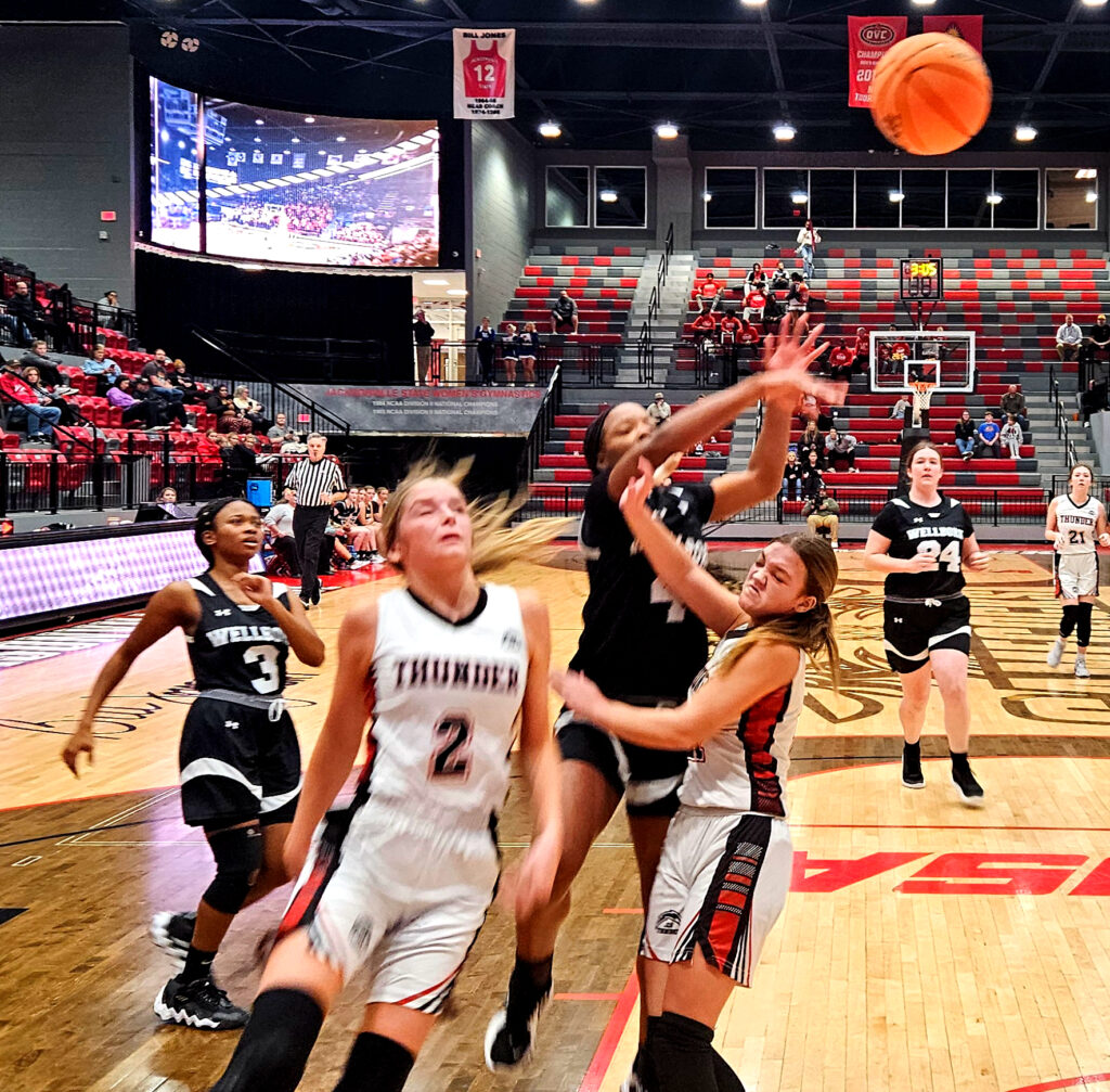 Wellborn’s Anna Odom drives and dishes against Jacksonville Christian during Monday’s action I the Calhoun County tournament. (Photo by Joe Medley)