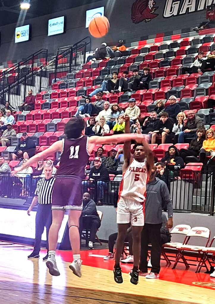 Saks’ Christian Smith hits a 3-pointer ahead of the halftime buzzer against Donoho during Monday’s action in the Calhoun County tournament at Pete Mathews Coliseum. (Photo by Joe Medley)