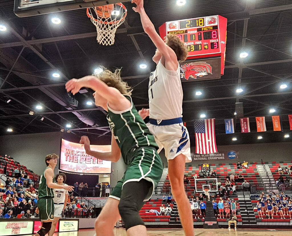 Piedmont’s Colton Procter goes up for two as Faith Christian’s Will Smith defends during Calhoun County tournament action Monday at Pete Mathews Coliseum. (Photo by Joe Medley)