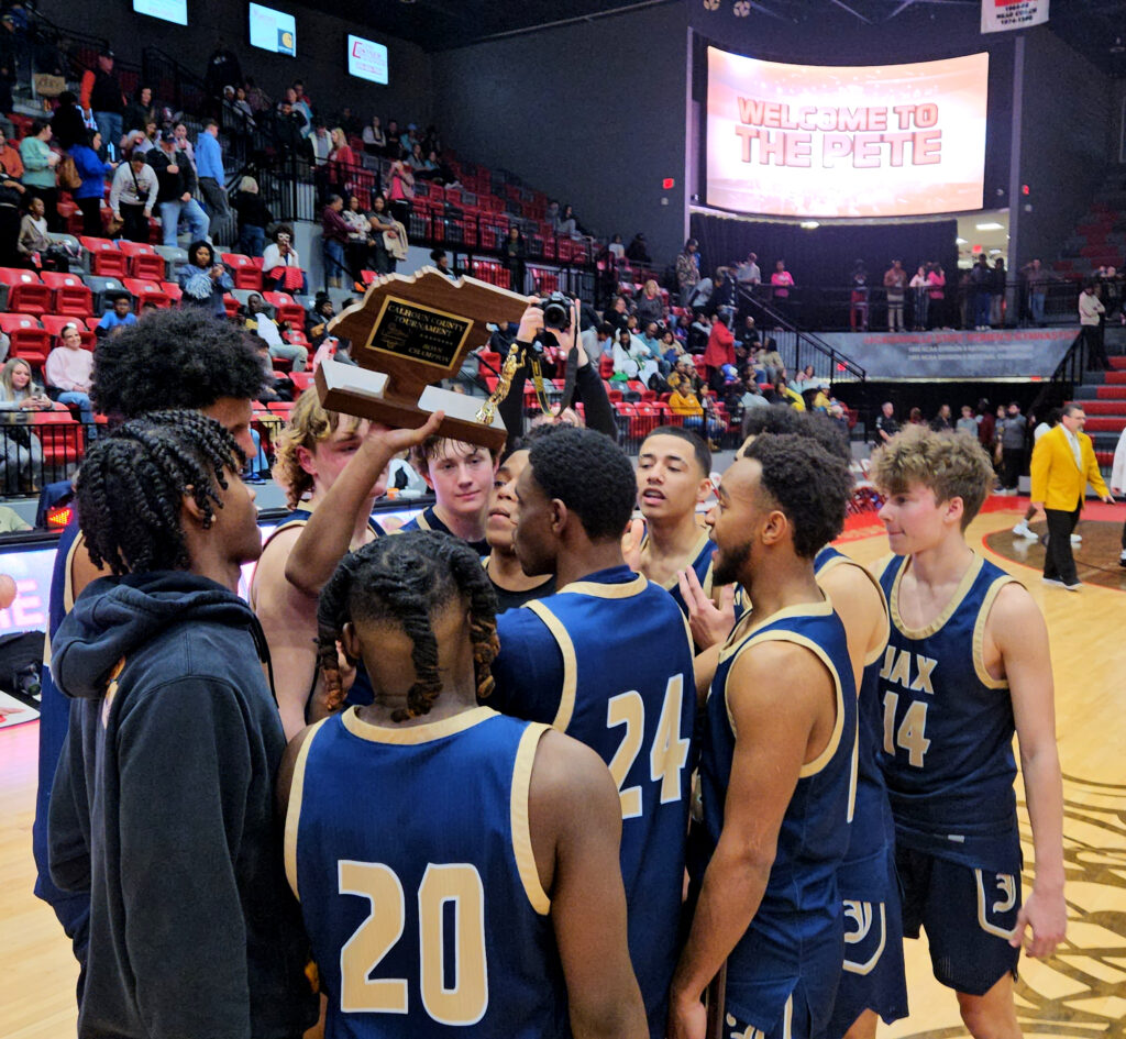 Jacksonville’s players collect their trophy after winning the 73rd annual Calhoun County tournament Friday in Pete Mathews Coliseum. (Photo by Joe Medley)