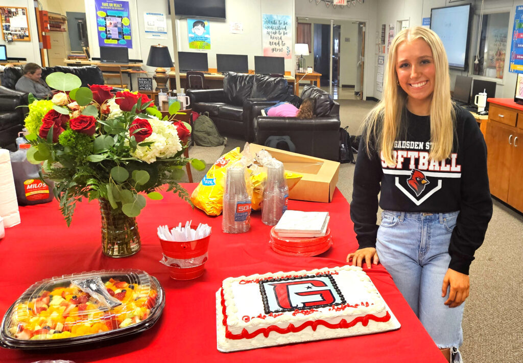 Ohatchee’s Ellie Carden with the signing-day cake that features the Gadsden State Community College logo Thursday at Ohatchee High School. (Photo by Joe Medley)