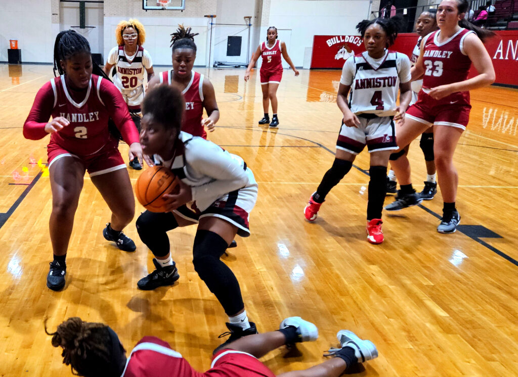 Anniston’s Tykeria Smith wins an offensive rebound against Anniston on Friday. (Photo by Joe Medley)