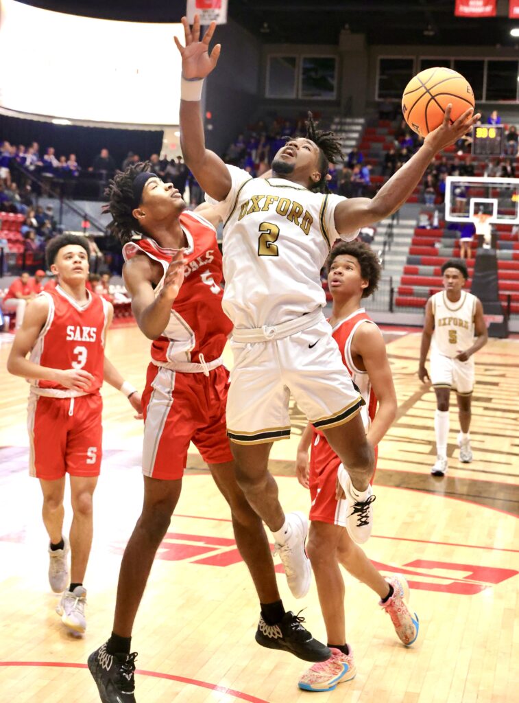 Oxford’s Dashaun Calloway drives to the hoop against Saks during Thursday’s Calhoun County quarterfinals at Pete Mathews Coliseum. (Photo by Stephen Gross/For East Alabama Sports Today)
