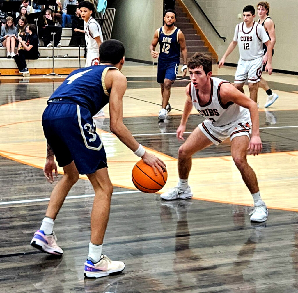 Alexandria’s Cleat Forrest defends as Jacksonville’s Devin Barksdale looks to drive on Thursday. (Photo by Joe Medley)