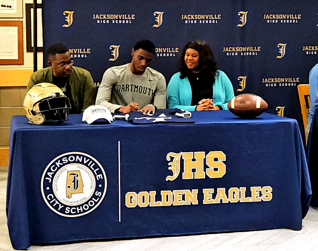 Ky’ric Fisher with his parents at Jacksonville High’s National Signing Day ceremony. (Photo by Joe Medley)