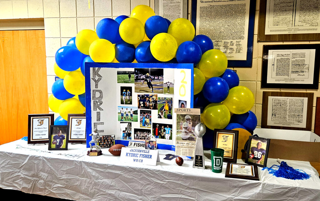 Memorabilia tables for Jacksonville’s Ky’dric Fisher and Maddie Holt at the school’s National Signing Day ceremony Wednesday. (Photos by Joe Medley)