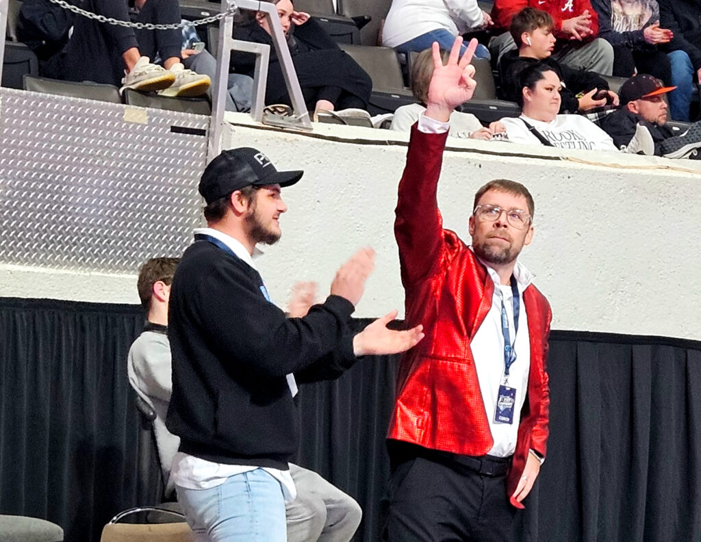 Weaver coach Andy Fulmer signals to Weaver’s cheering section the moment the Bearcats clinched their third consecutive conventional Class 1A-4A state title. (Photo by Joe Medley)