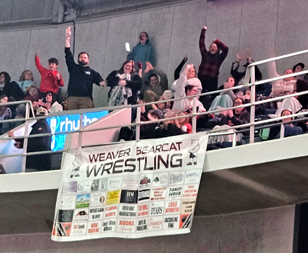 Weaver’s cheering section reacts after the Bearcats clinched their third consecutive Class 1A-4A state wrestling title on Saturday in Huntsville’s Von Braun Center. (Photo by Joe Medley)