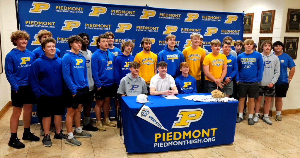 McClane Mohon and his Piedmont baseball teammates pose for pictures during his signing ceremony Wednesday. (Photo by Joe Medley)