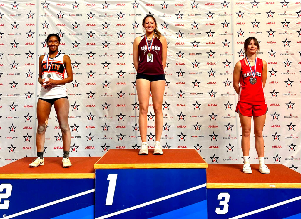Cover photo: Donoho’s Estella Connell tops the podium after repeating as state Class 1A-3A indoor long-jump champions Friday at Birmingham CrossPlex. (Submitted photo)