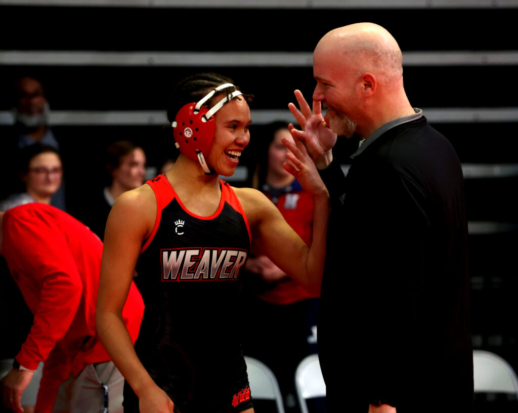 Weaver’s Lena Johannson and assistant coach Justin Brown celebrate after she won her fourth individual state title. (Submitted photo)