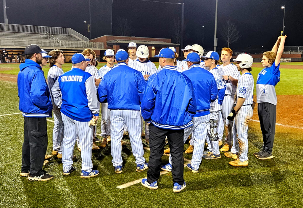 White Plains huddles after beating Wellborn in the Calhoun County tournament on Saturday at Choccolocco Park. (Photo by Joe Medley)