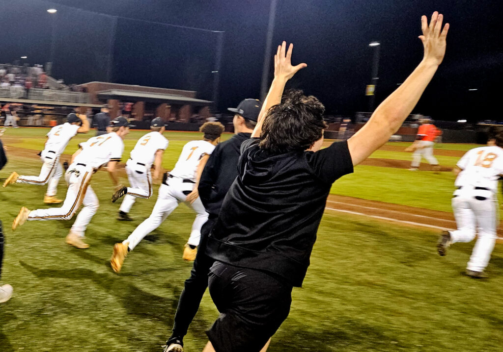 Oxford players charge the field to celebrate their victory over Alexandria in Thursday’s Calhoun County championship game. (Photo by Joe Medley)