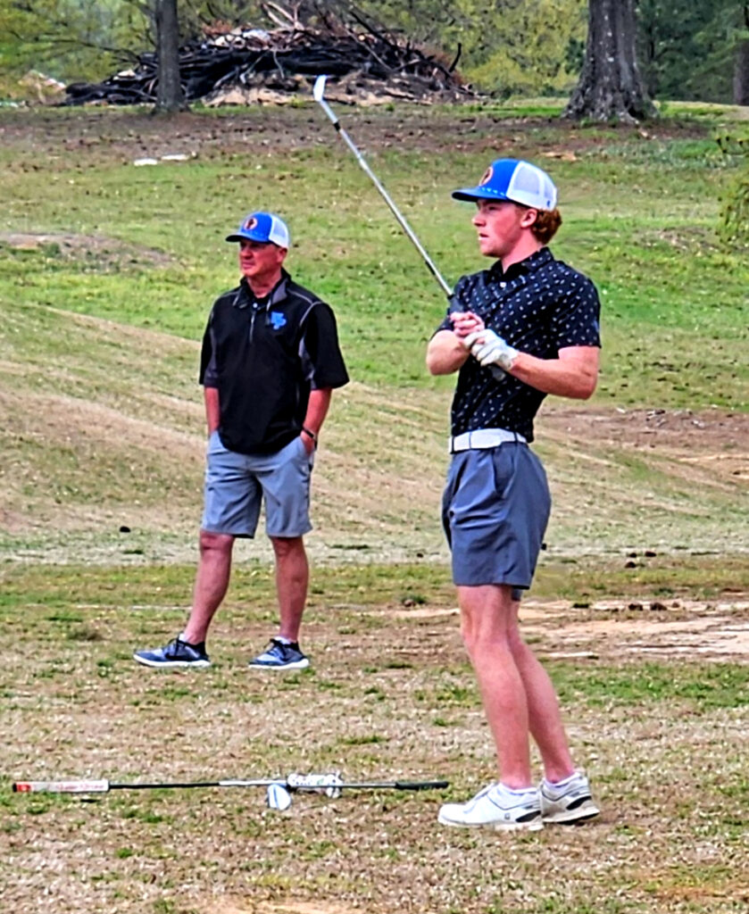 White Plains’ Sawyer Edwards chips on No. 17 during Monday’s first round of the Calhoun County tournament at Pine Hill Country Club. He shot 68 and leads. (Photo by Joe Medley)