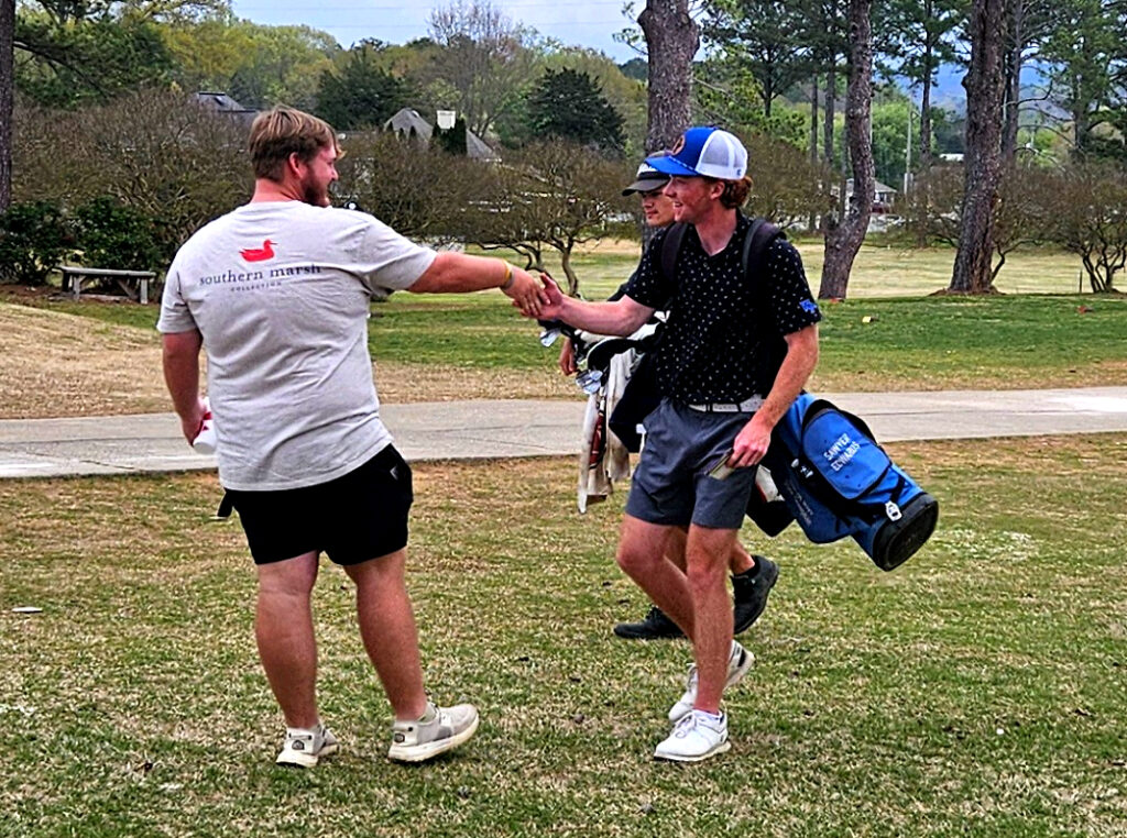 Weaver graduate Nick Led better, the 2023 Calhoun County champion, greets White Plains’ Sawyer Edwards after Edwards completed his first round Monday. (Photo by Joe Medley)