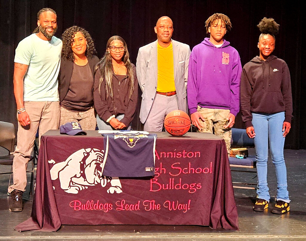 Anniston’s A’Kayla Perry, center left, poses with family and Southern Union Community College coach Earl Taylor during Friday’s signing ceremony at Anniston High School. (Photo by Joe Medley)