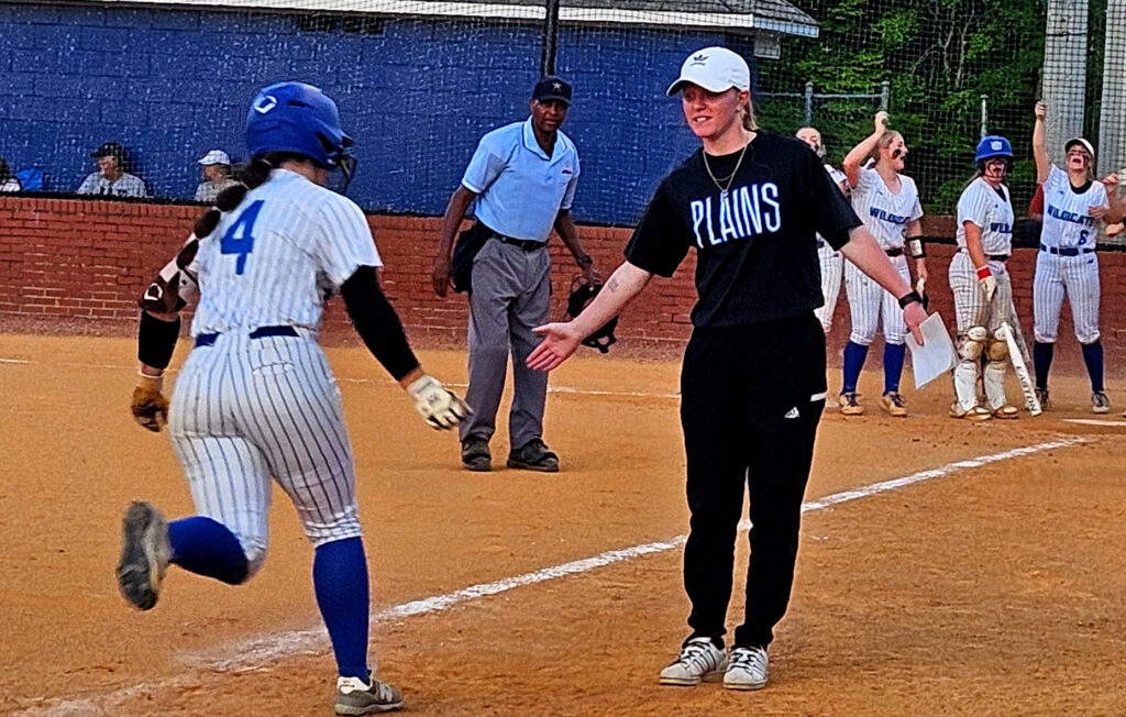 White Plains assistant coach Savannah Sudduth congratulates Callie Richardson after Richardson’s second home run against Jacksonville in Tuesday’s Class 4A, Area 10 final at White Plains. (Photo by Joe Medley)