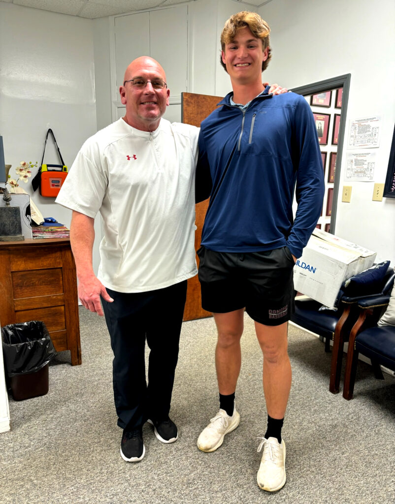 New Donoho head football coach and strength coach Bill Smith meets with Falcons wide receiver/safety Hayes Farrell. (Submitted photo)