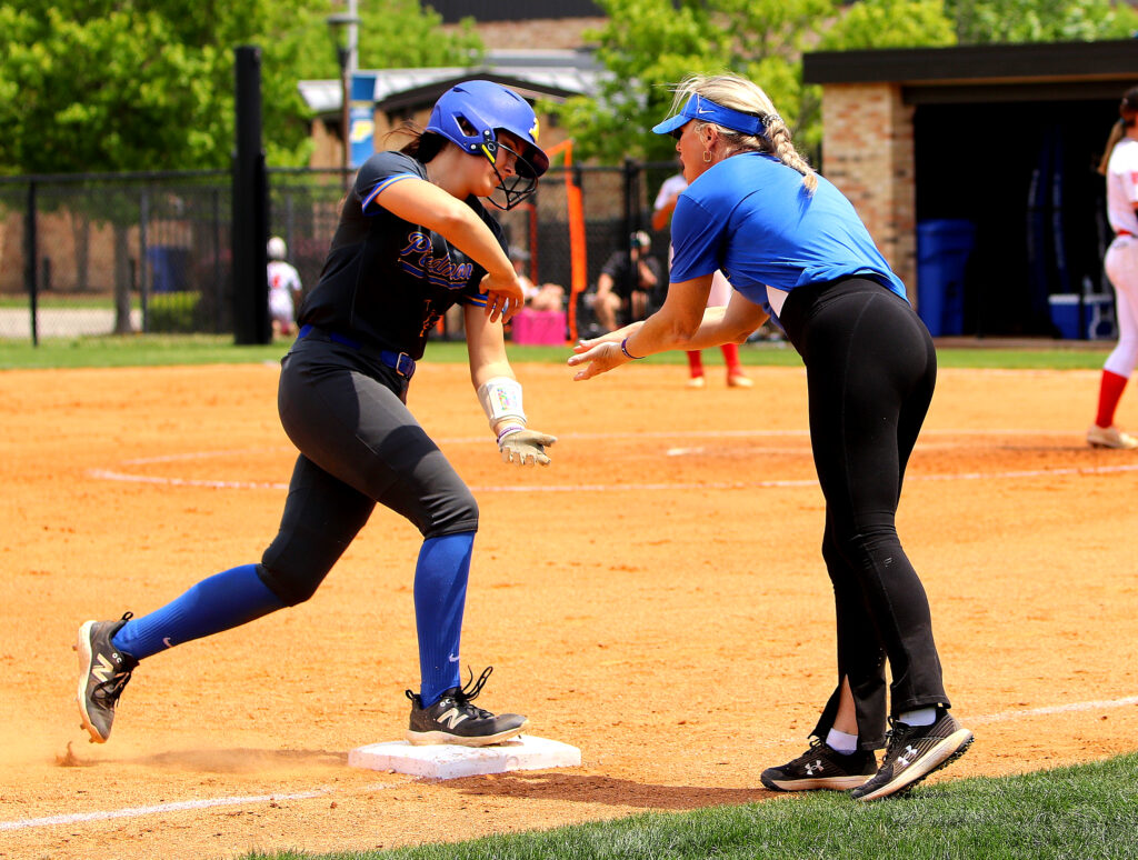 Piedmont’s Cacey Brothers gets congratulations from her head coach, Rachel Smith, after hitting a home run against Saks in Saturday’s Class 3A, Area 10 tournament action. (Photo by Jean Blackstone/For East Alabama Sports Today)